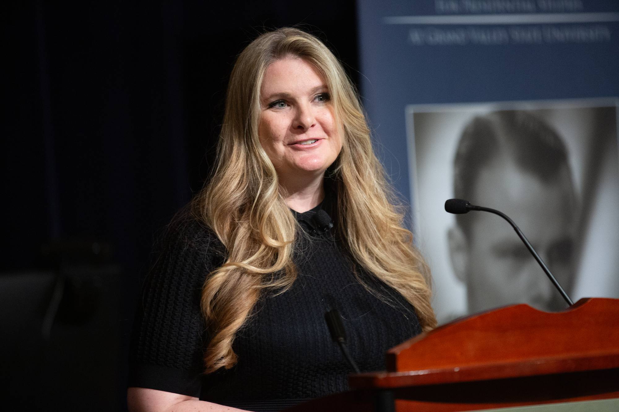 person speaking at a podium
